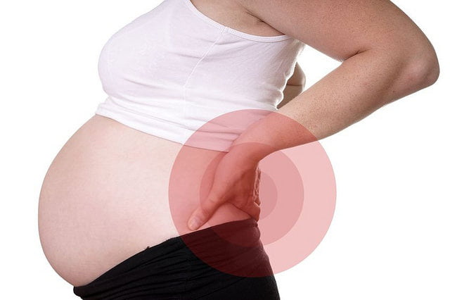 when does back pain start in pregnancy
